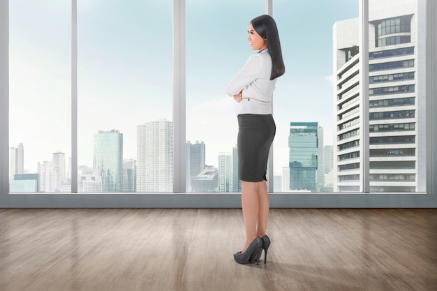 Side view of asian business woman standing on office room