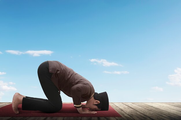 Side view of asian muslim man praying