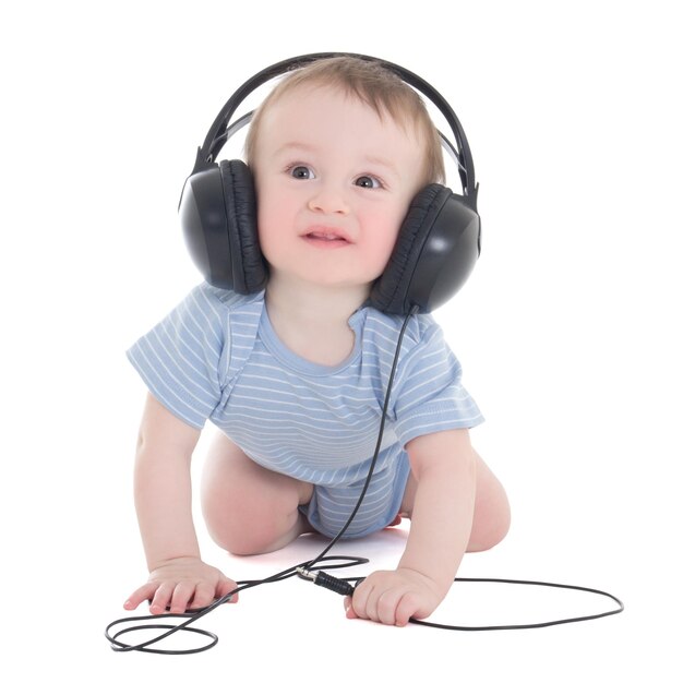 Side view of baby boy toddler listening music with earphones isolated on white background