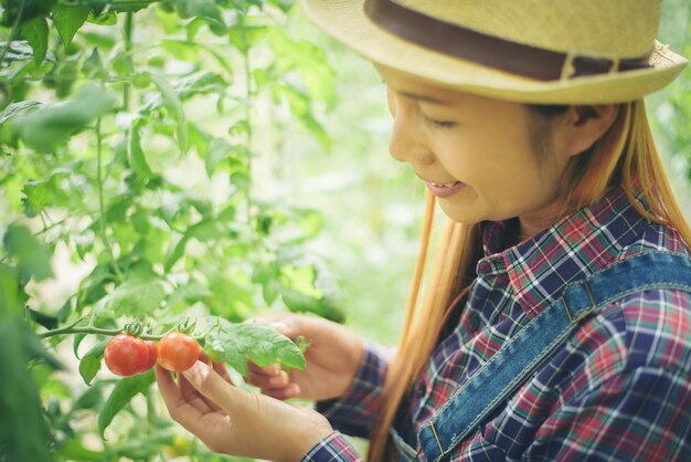 Side view of baby girl holding plant