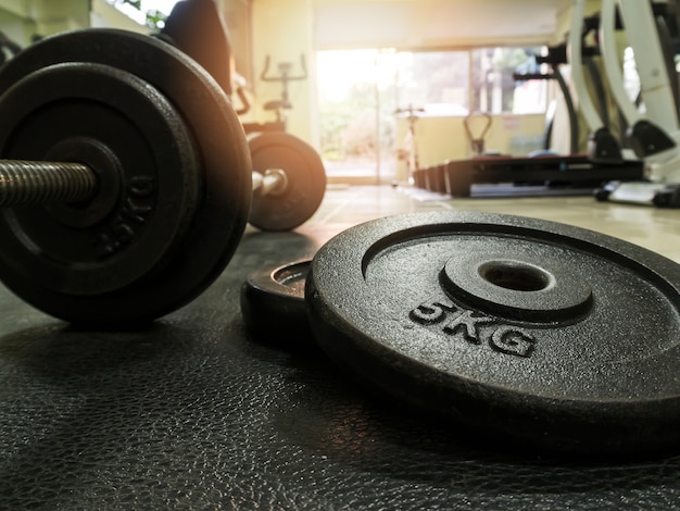 Side view of barbell on the floor in fitness gym