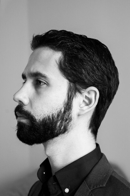 Side view of bearded young man looking away