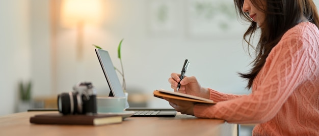 Side view of Beautiful business woman write something business plan creative idea on her notebook