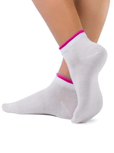 Side view of beautiful woman foot dressed in new nice and soft natural cotton fabric blank white socks with red edging