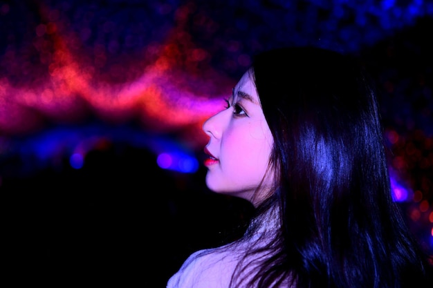side view of beautiful woman standing in nightclub