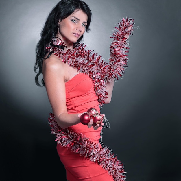 Side view.beautiful young woman in a red dress. isolated on black.photo with copy space.