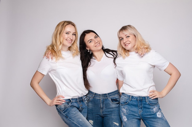 Side view of beautiful young women standing one by one