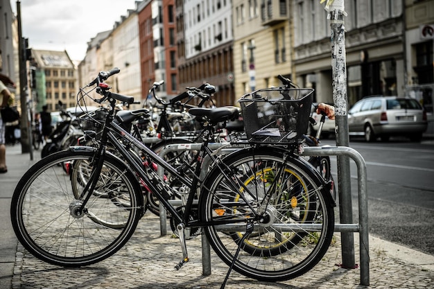 Side view of bicycles parked in row against buildings