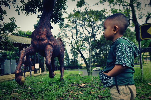 Side view of boy on field