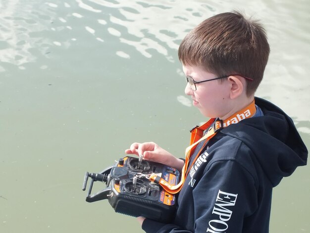 Side view of a boy holding a water