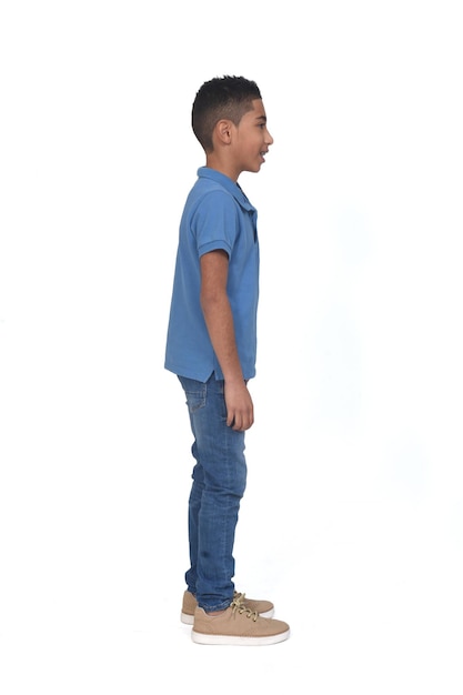 Photo side view of boy  looking  on white background