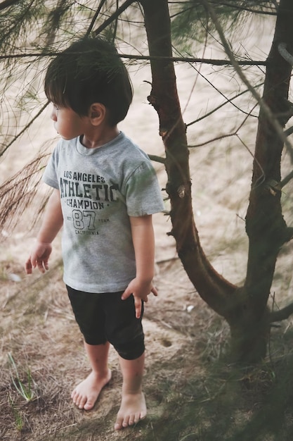 Side view of boy standing on field