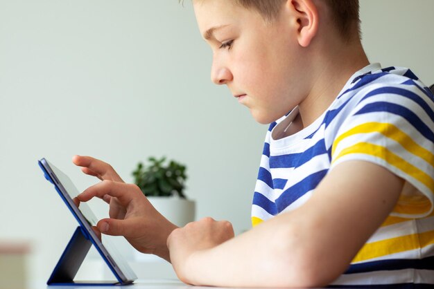 Side view of boy using mobile phone