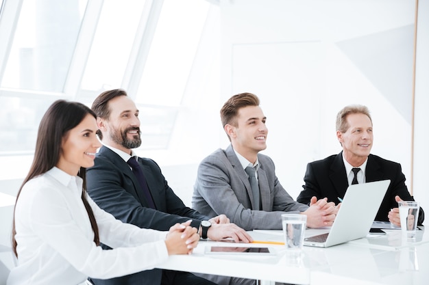 Side view of Business people sit by the table in conference room