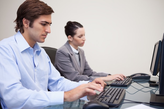 Side view of business team working next to each other