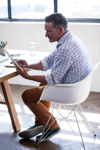 Side view of businessman using a tablet computer