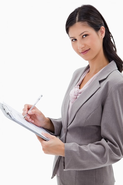 Side view of businesswoman taking notes