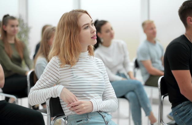 Side view casual group of young people sitting in conference room