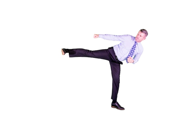 Side view of Caucasian businessman looks angry while kicking copy space in the studio Isolated on white background