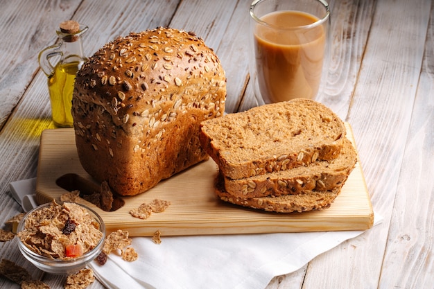 Side view on cereal bread loafs on the wooden decorated background