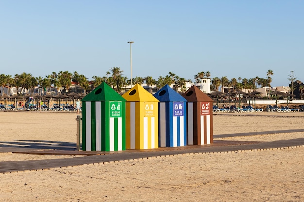 side view of colorful trash cans on Caleta de Fuste beach, Fuerteventura