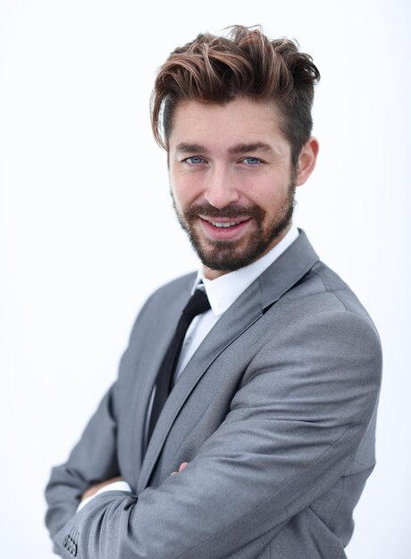 Side view of a confident handsome businessman with his arms crossed and looking at the camera