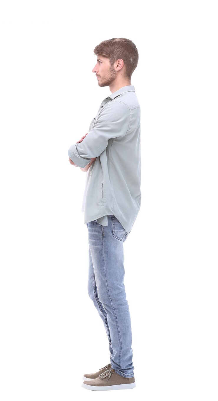 Photo side view confident young man in jeans isolated on white background