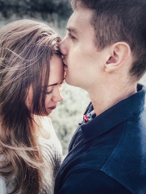 Side view of couple embracing outdoors