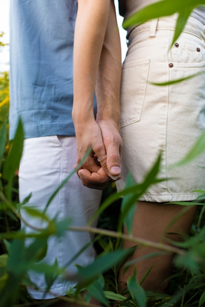 Side view couple holding hands outdoors