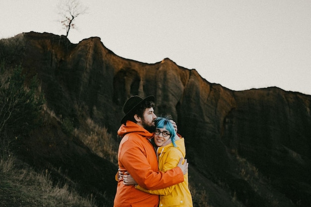side view of couple standing on mountain