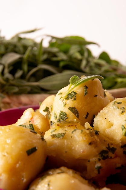 Side view Delicious Fried Gnocci with sage butter in a pink bowl