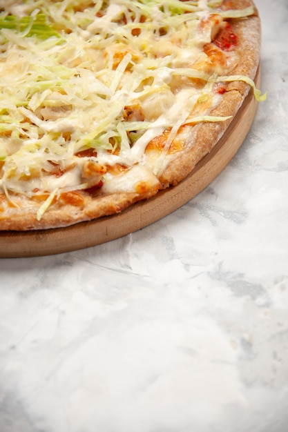 Side view of delicious homemade vegan pizza on the top on stained white surface