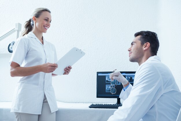 Side view of dentists discussing reports