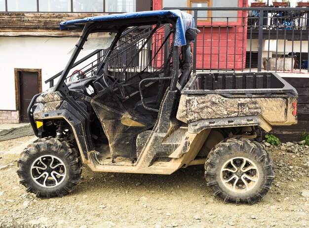 Photo side view of dirty buggy. atv vehicle for extreme off-road riding extreme