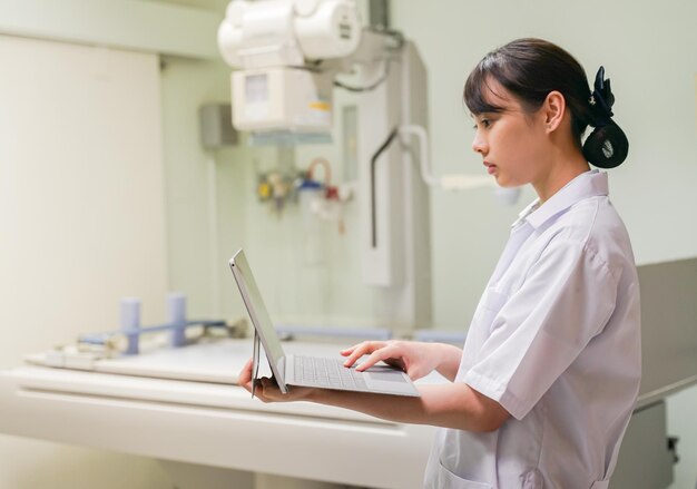 Photo side view of doctor using laptop