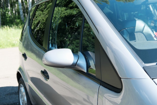 Side view of a exterior of metallic car and its rear view\
mirror travelling and car jorney concept