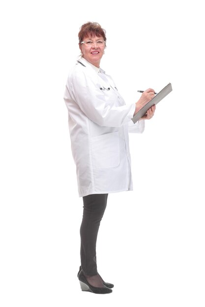 Side view of female doctor filling up medical form on clipboard