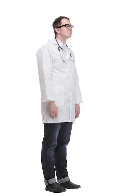 Side view full length confident male medical doctor in uniform looking at camera