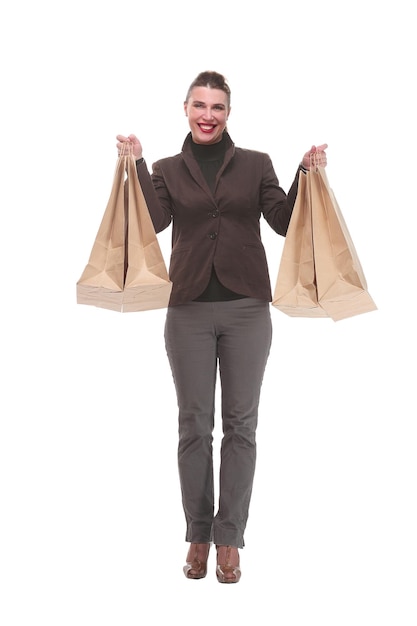 Side view full length portrait of young woman with shopping bags