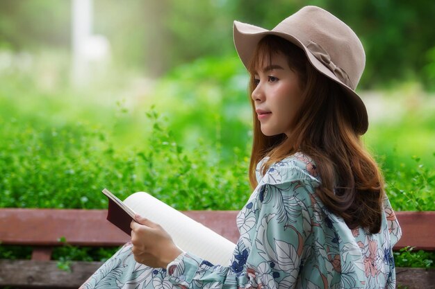 Side view of a girl holding hat