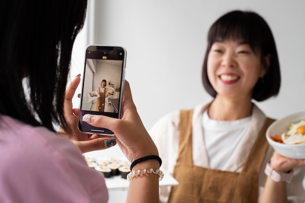 Photo side view girl taking photos of woman