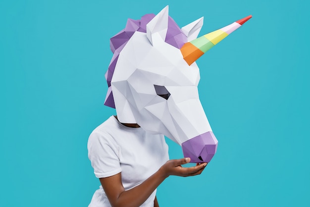 Side view of girl in white shirt wearing papercraft