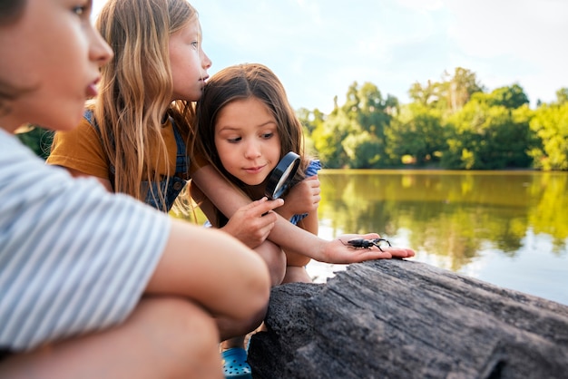 side view girls with magnifying glass