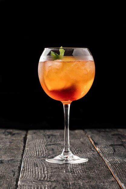 Side view on a glass of aperole spritz cocktail