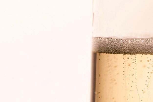 Side view glass with sparkle champagne bubbles