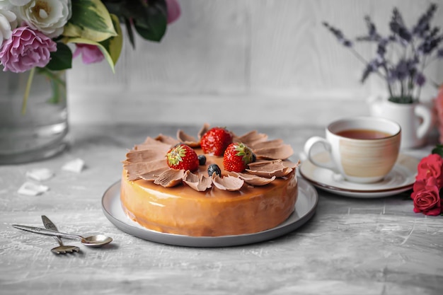 Side view on glazed caramel cake with berries