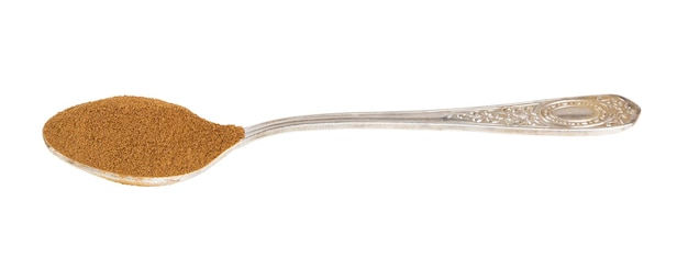 Side view of ground roasted chicory root in spoon