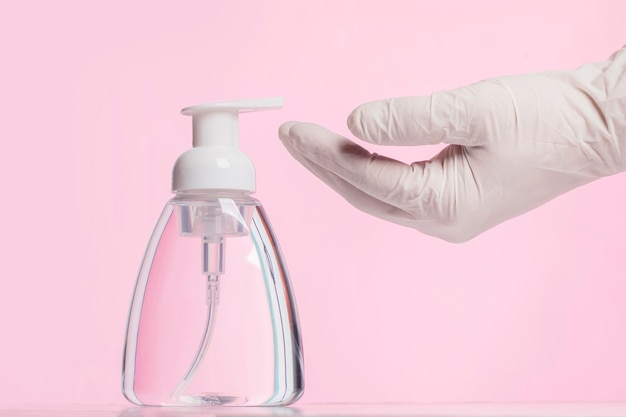 Side view of hands with surgical glove using disinfectant