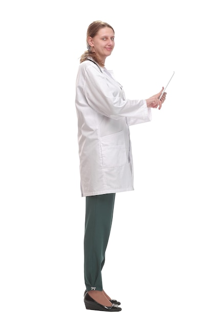 Side view of happy female doctor writing patient chart on digital tablet