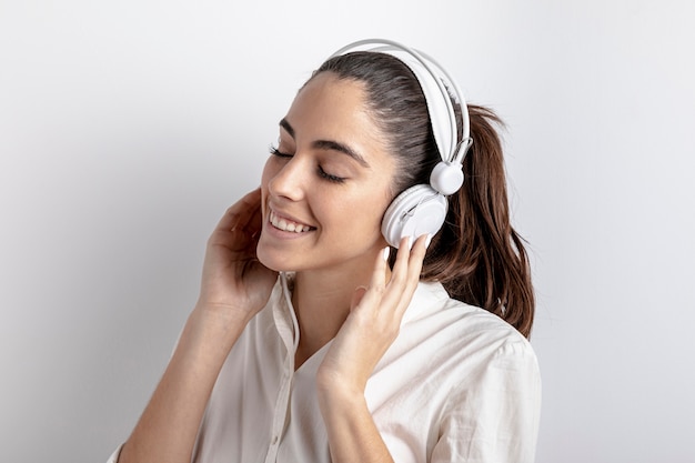 Photo side view of happy woman with headphones on